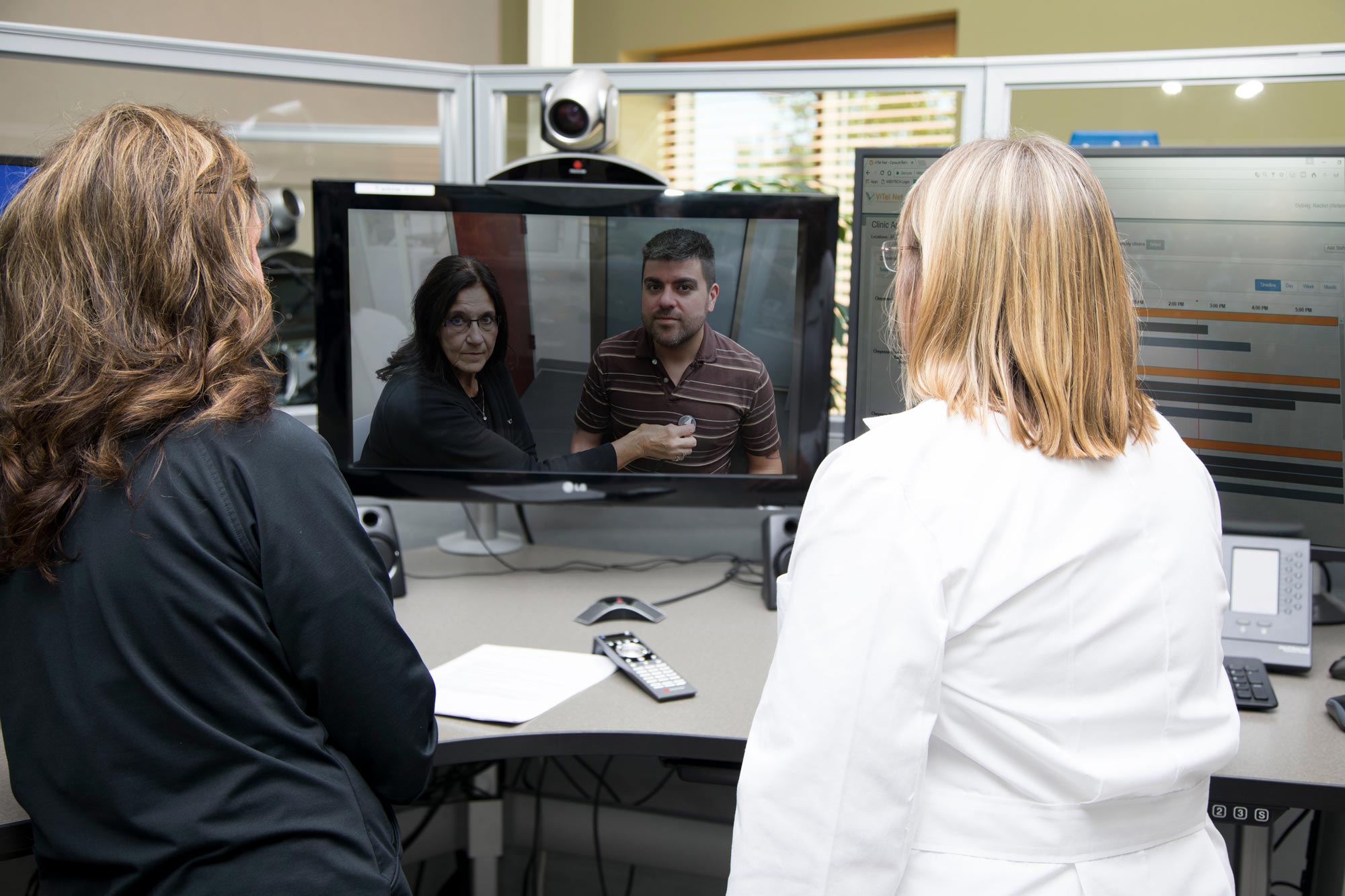 nurses with patient through the computer